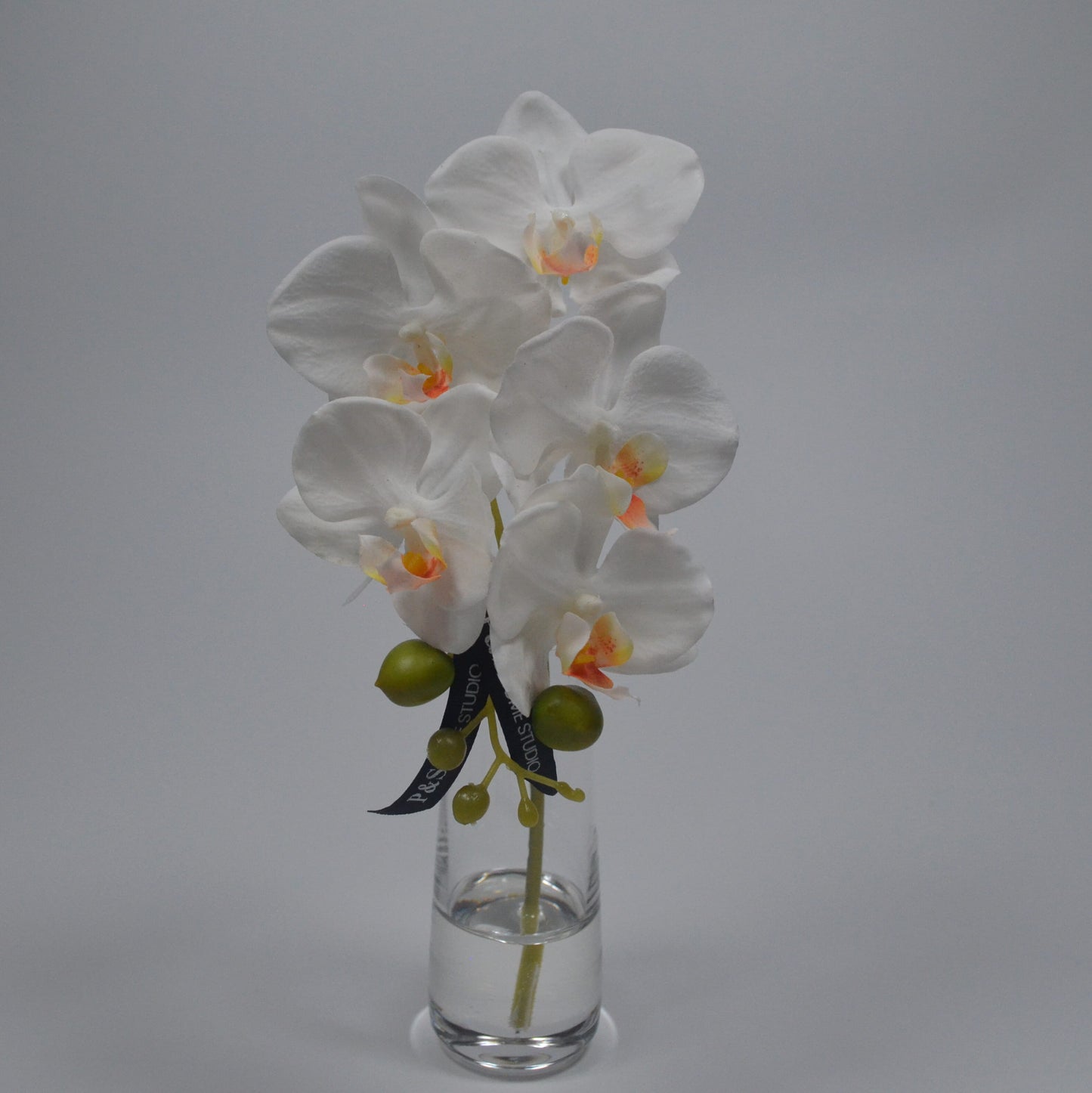 White orchid in a clear vase in resin water