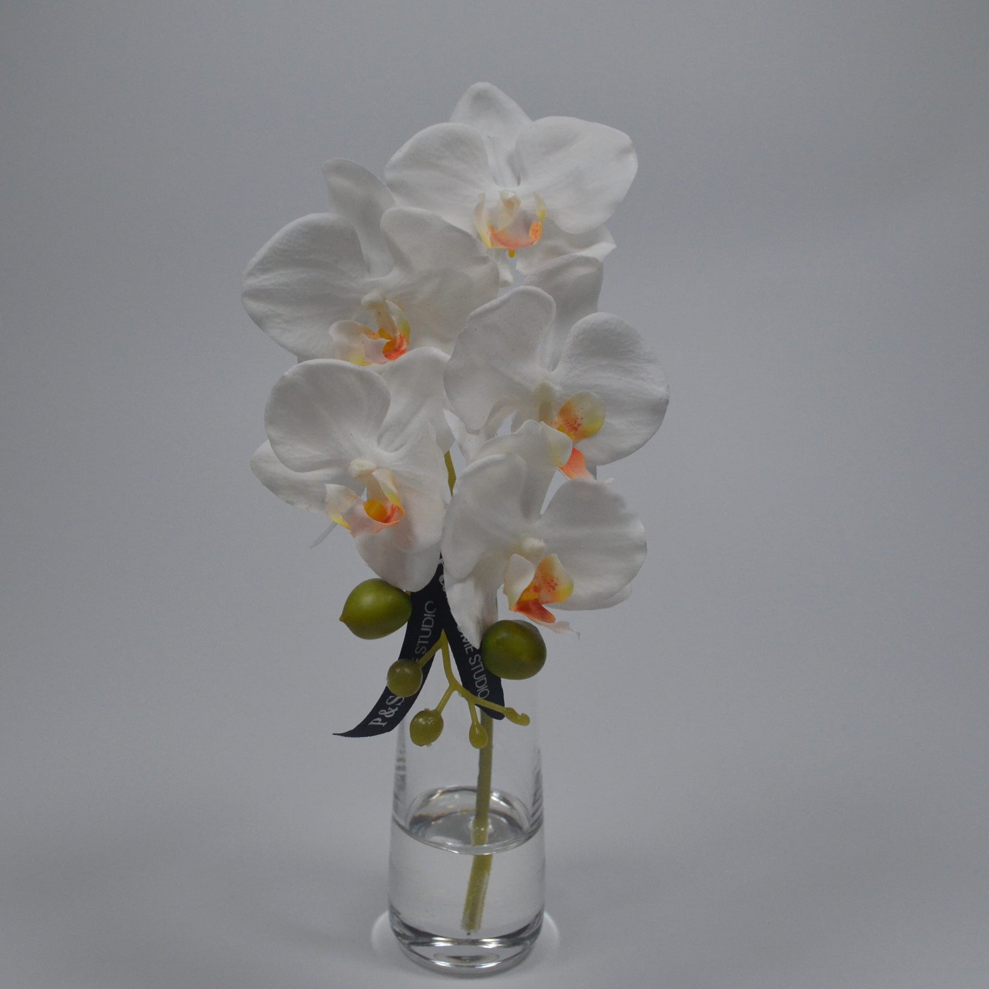 White orchid in a clear vase in resin water